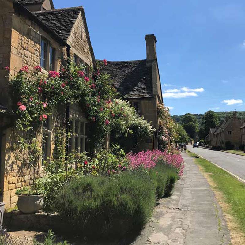 Historic honey stone buildings on Broadway High Street in the Cotswolds
