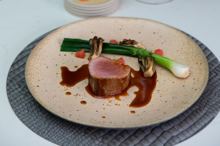 Intimate 12-seat chef's counter at MO restaurant with chefs preparing dishes interactively