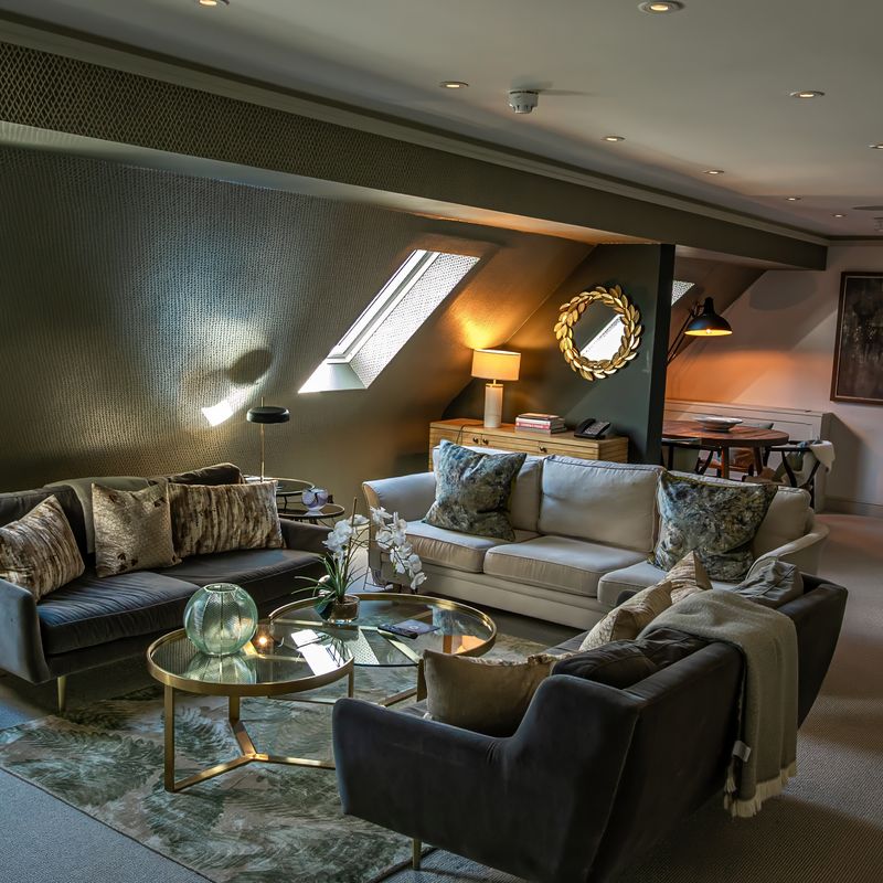 The Studio luxury suite interior with contemporary velvet sofa and curated vinyl player