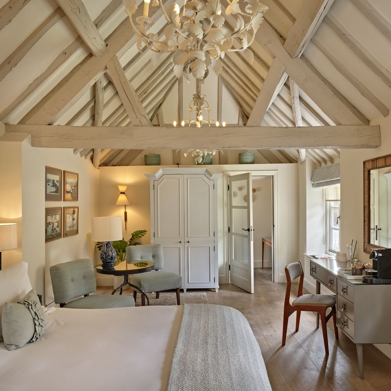 Top-Notch luxury bedroom with exposed original beams and freestanding bathtub
